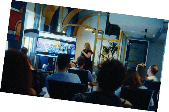 The team watching a presentation in the studio