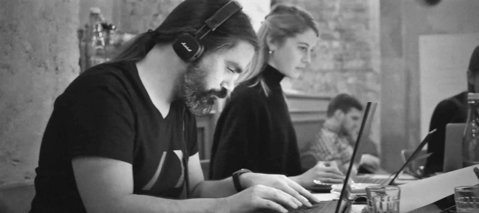 REBORRN team members working on laptops around a shared table