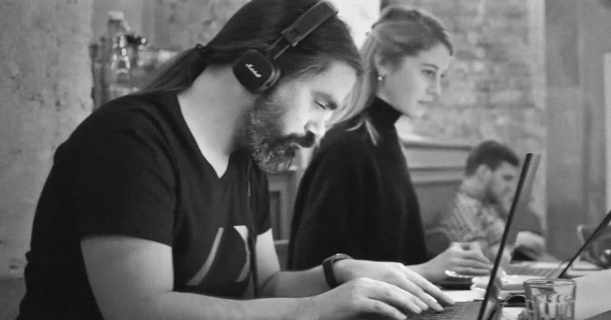 REBORRN team members working on laptops around a shared table